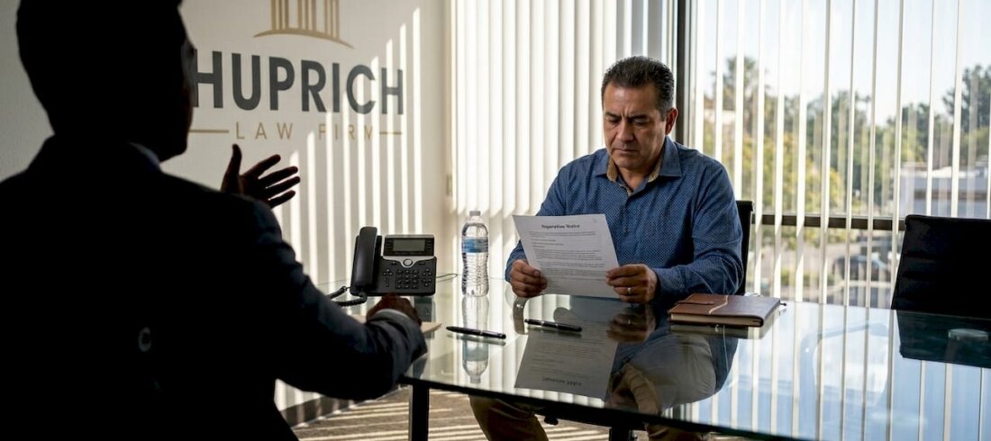 Worker receiving termination notice at office table