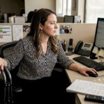 Media worker reading accommodation request at desk